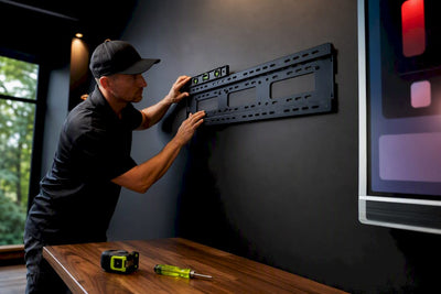 Installer preparing home scoreboard mounting hardware