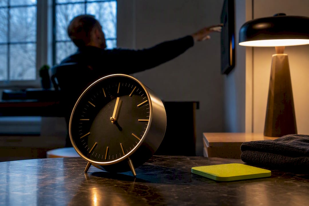 Analog clock beside an ambient sports display