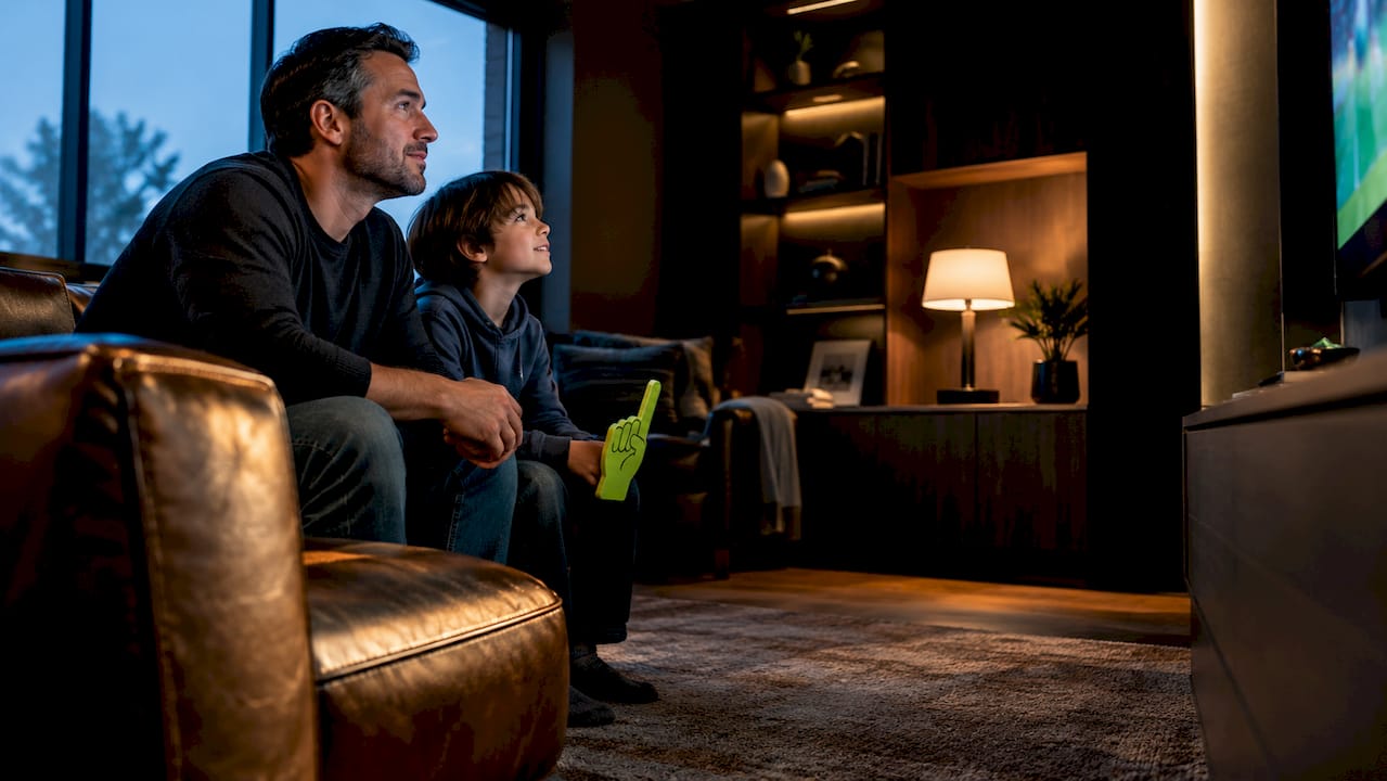 Parent and child viewing a sports score display