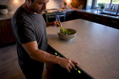Parent checking sports display in kitchen